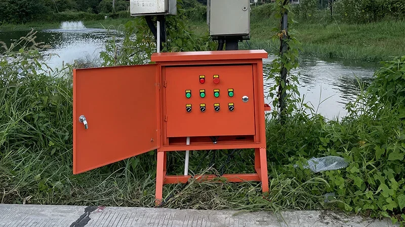 Outdoor equipment control cabinet beside an aquaculture pond